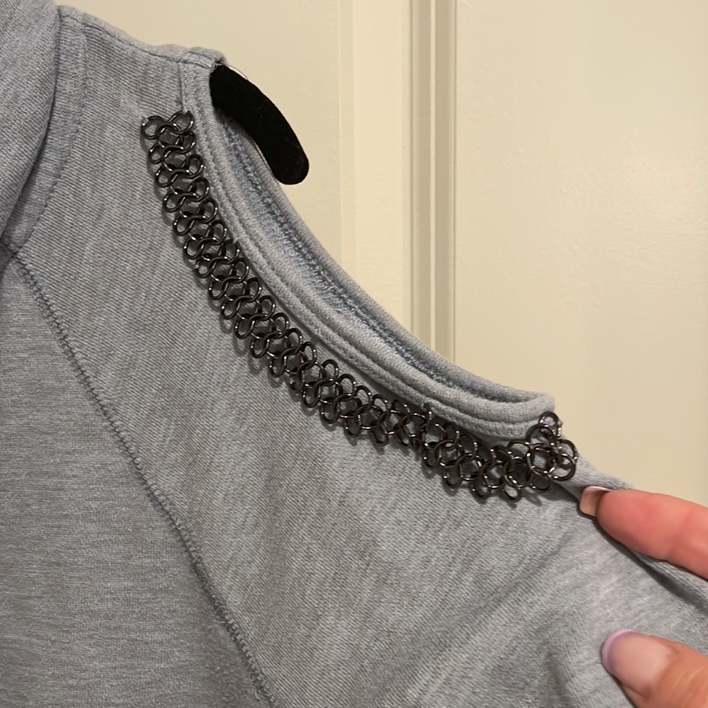 Full zip hooded sweatshirt with metal cold shoulder details.